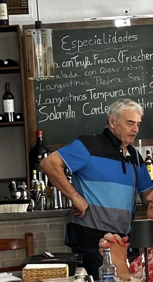 Christian at the bar in front of the specials board